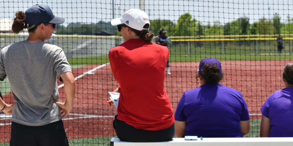 Softball athlete interacting with a college coach at a showcase