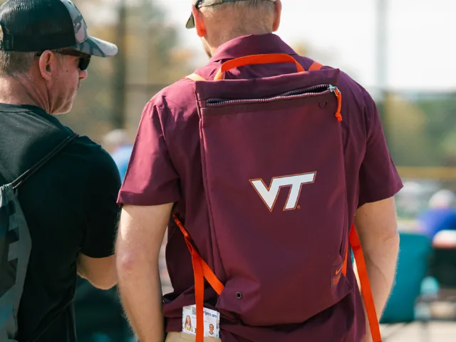 College coach providing feedback to a softball athlete